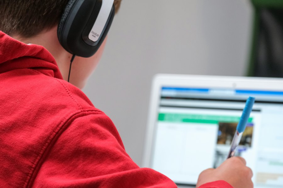 A student studying online with headphones